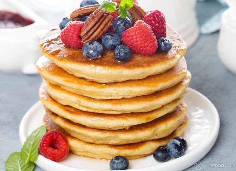 2021-09-13-6sthej-stack-of-fluffy-pancakes-with-fresh-berries-and-pe-uej8wg5