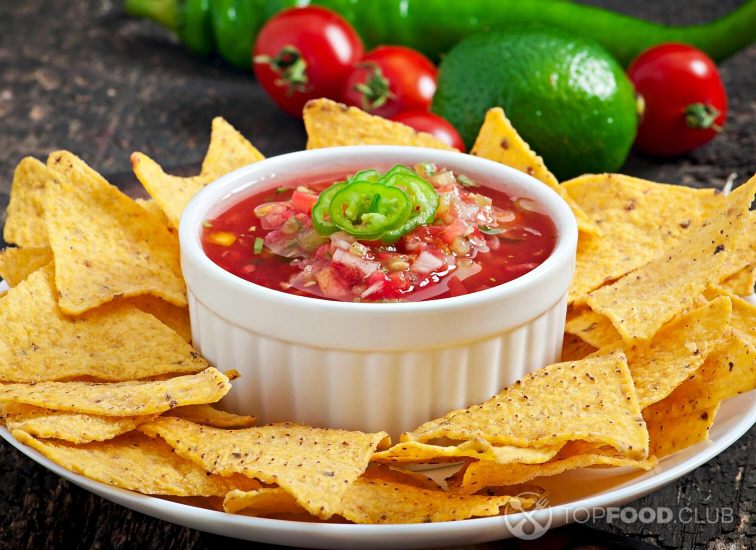 2021-11-02-xy4w8m-mexican-nacho-chips-and-salsa-dip-in-bowl-on-wooden