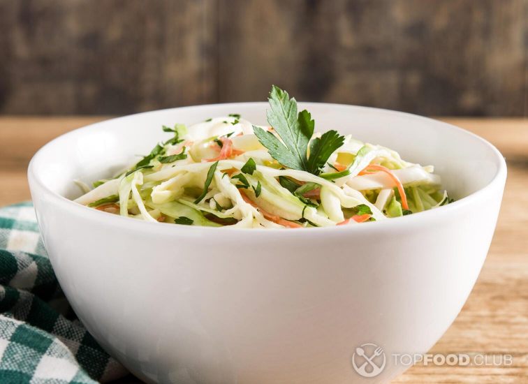 2021-11-26-42et5n-coleslaw-salad-in-white-bowl-on-wooden-table