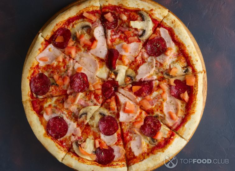 2023-03-05-i5aer0-top-view-of-pizza-with-champignon-ham-and-sausage-2022-04-01-23-08-40-utc