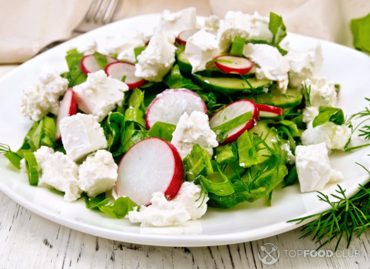 2023-05-27-iwg80e-salad-with-cheese-and-radishes-in-plate-on-board-2021-08-26-16-02-44-utc