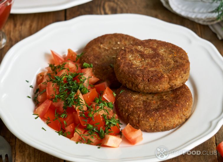 2023-06-26-1dc3yg-buckwheat-cutlets-with-fresh-tomato-salad-on-a-white-plate