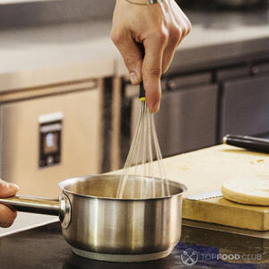 размешивает в кастрюле