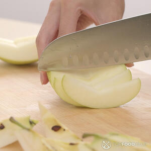 нарезает яблоко