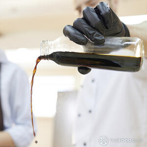 наливает соевый соус