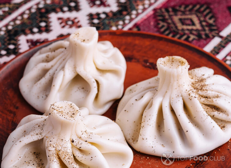 2025-05-08-3z0isp-traditional-georgian-khinkali-on-rustic-plate-2025-02-21-11-50-00-utc