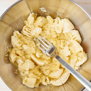 Mash bananas with a fork.