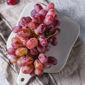 Rinse the grapes, then cut in half and remove the seeds.