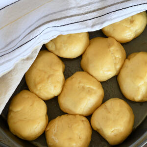 Make the balls from dough. Cut out a circle in the center of the ball, using a shot glass.