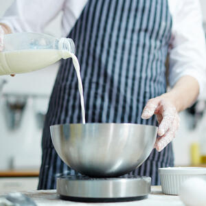 Heat milk, but do not bring to a boil. Pour dry yeast into a warm (!) milk. Add sugar. Mix well.