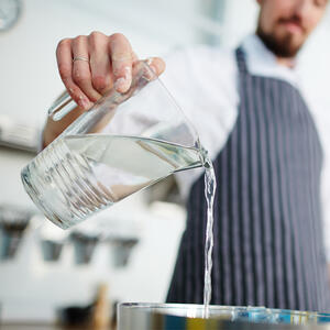 Pour water into a pot.
