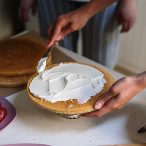 Place one trimmed layer on a cake stand or serving platter.