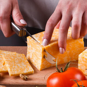 Cut the cheese into 2 parts and put on top of the chicken.