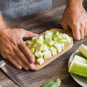 Finely chop the tomatoes with zucchini.