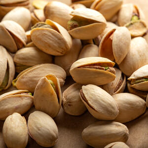 Toast the pistachios in a pan over a medium heat until golden.