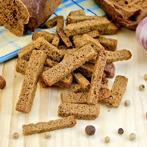 Cut the slices of bread into long strips (like croutons).