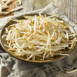 Wash bean sprout and bok choy salad under running water.