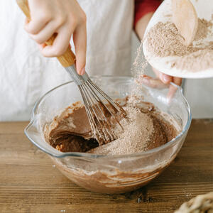 In a large bowl, stir together the white sugar, flour, cocoa, and baking soda. 