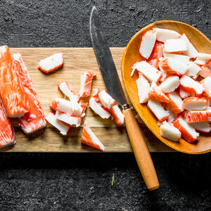 Defrost the crab sticks, then cut them.