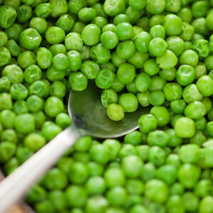 Defrost frozen green peas under hot water.