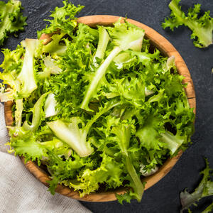 Tear large leaves from Frisee greens.