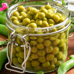 Open the can of green peas, pour off the water