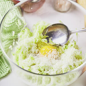 Add egg and flour to zucchini