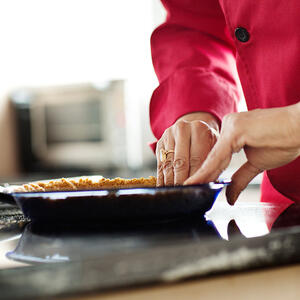 Placing cookie crust in tin