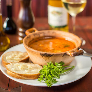 Serve the soup with garlic bread and place fish heads in bowls