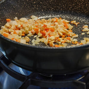 Fry diced onion, garlic and carrots until brown