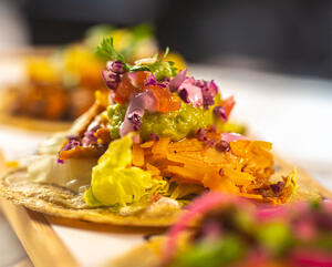 sprinkle the tortillas with the hot ground beef mixture, sour cream, cheese, lettuce, green onions 