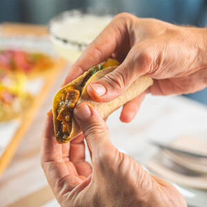 fold the tortillas in half and press them slightly