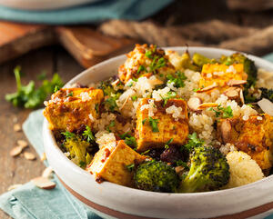 divide rice tofu vegetables and fried beans among bowls