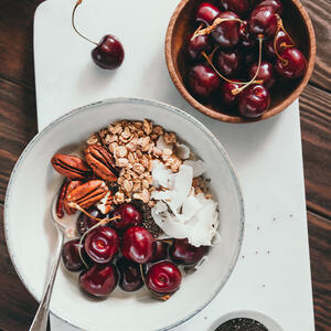 Sprinkle with remaining cherries and decorate with cocoa beans