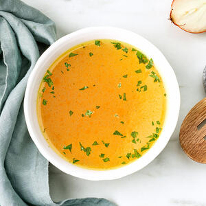 Boil ginger, lemongrass and lime leaves in chicken broth