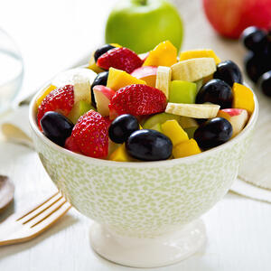 pour the lemon juice over the fruit salad