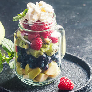 pour the cream over the fruits