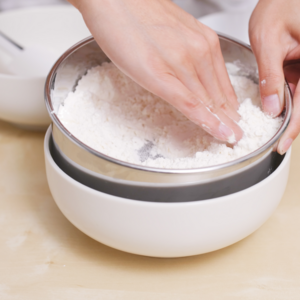 Add the baking powder to the flour. Mix to incorporate.