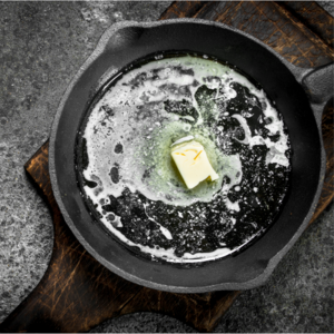a heated pan with a cube of butter