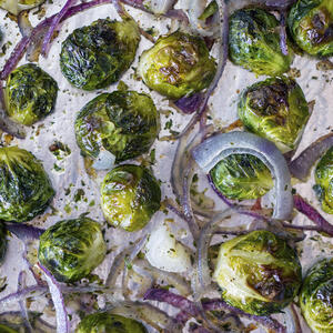 Mix in baking sheet washed Brussels sprouts, chopped garlic, chopped shallot and 3 tbs of olive oil. 