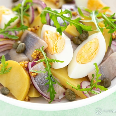 Egg salad with salted herring fillet