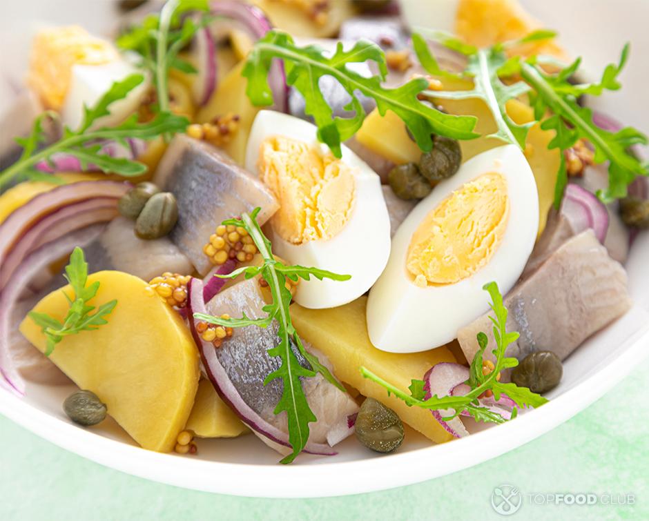 Egg salad with salted herring fillet